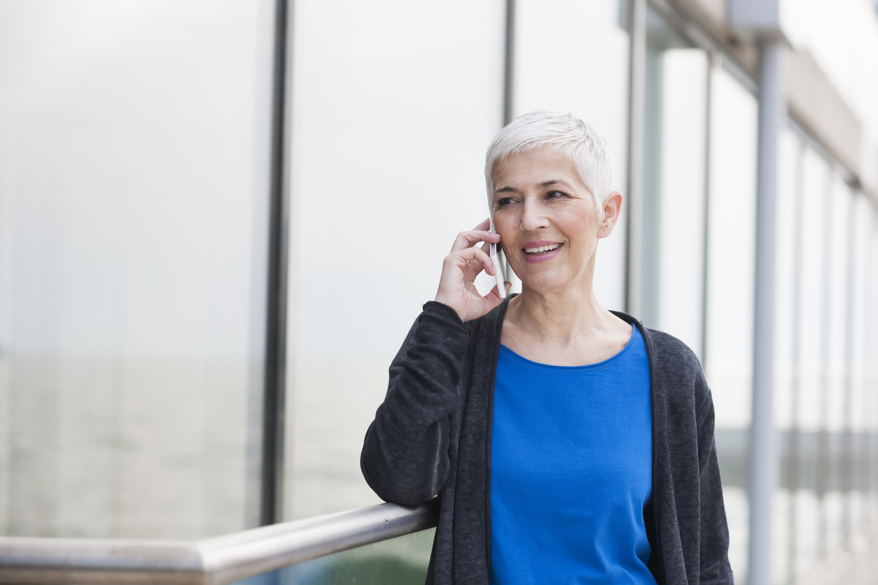 Smiling woman using mobile phone